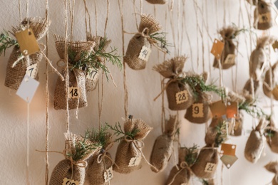 New Year advent calendar hanging on beige wall indoors, closeup