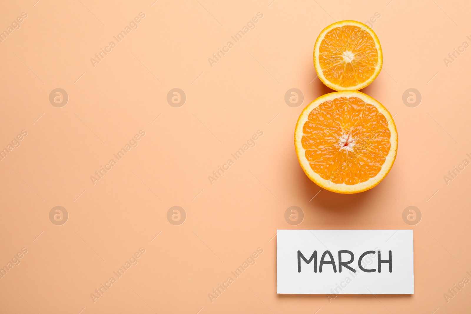 Photo of 8 March greeting card design with cut citrus and space for text on orange background, flat lay. International Women's day