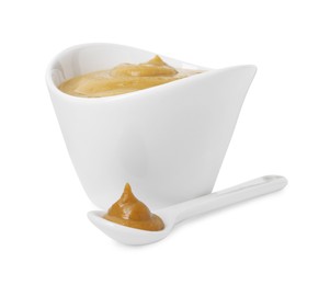 Photo of Fresh tasty mustard sauce in bowl and spoon isolated on white