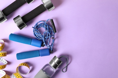 Photo of Flat lay composition with fitness gym equipment on color background. Space for text