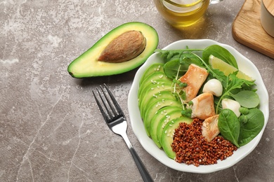 Photo of Delicious avocado salad with chicken on light grey marble table, flat lay