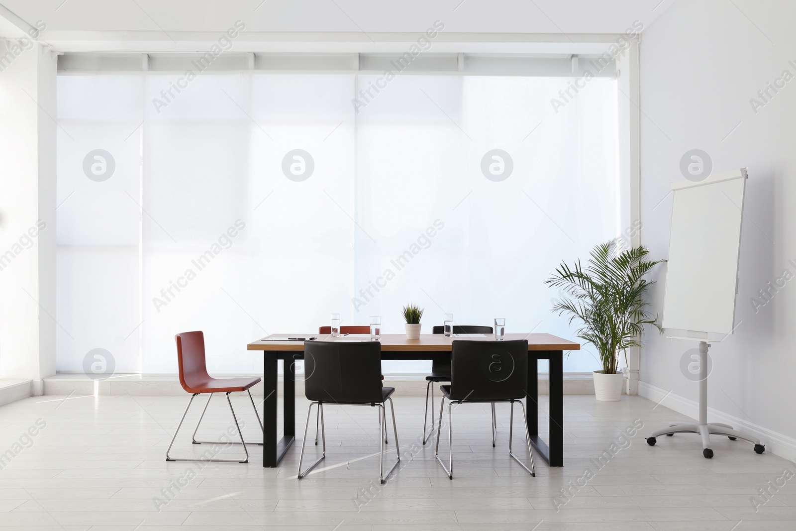 Photo of Simple office interior with large table and chairs