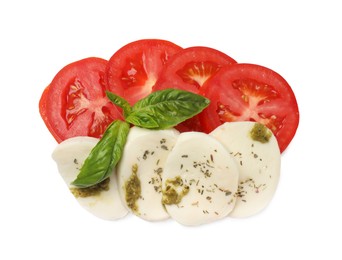 Photo of Tasty salad Caprese with mozzarella, tomatoes, basil and pesto sauce isolated on white, top view