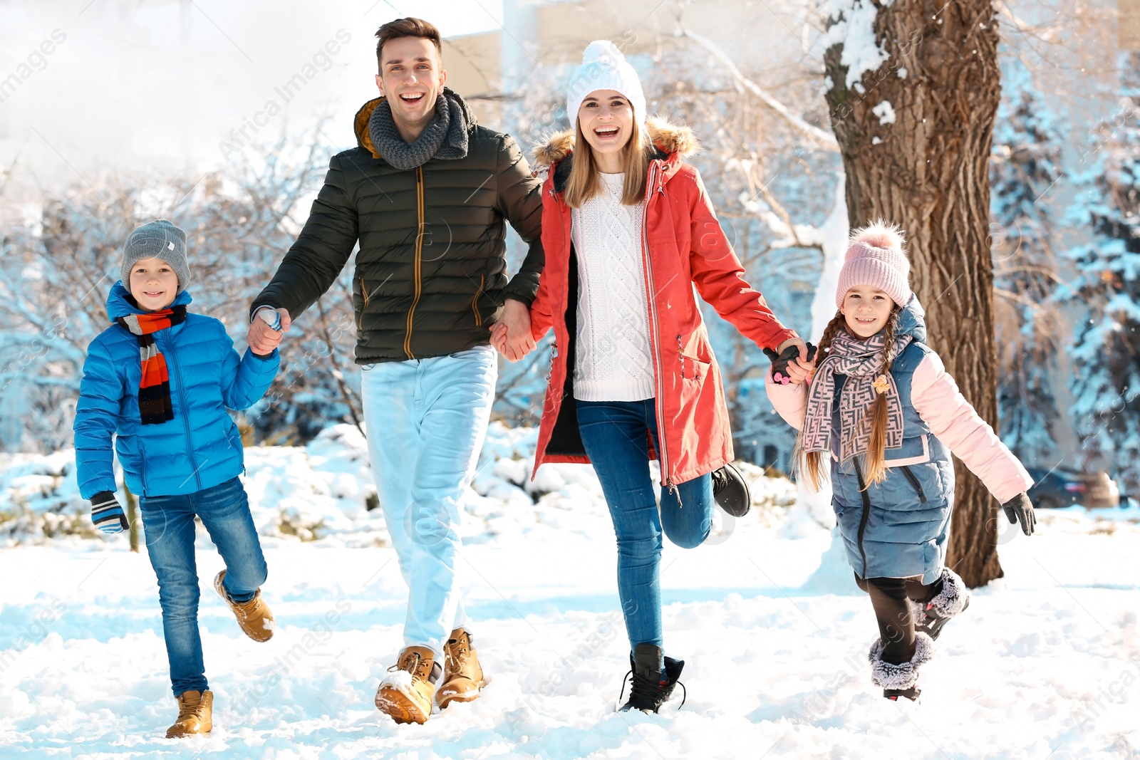 Photo of Happy family walking in winter park