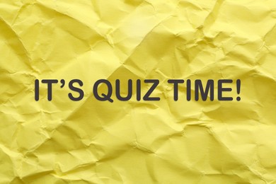 Image of Phrase IT'S QUIZ TIME on crumpled yellow paper 