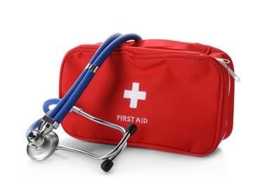 Photo of First aid kit with stethoscope on white background