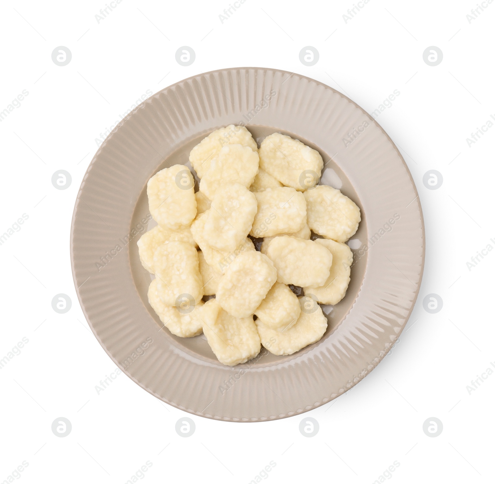 Photo of Plate of tasty lazy dumplings isolated on white, top view