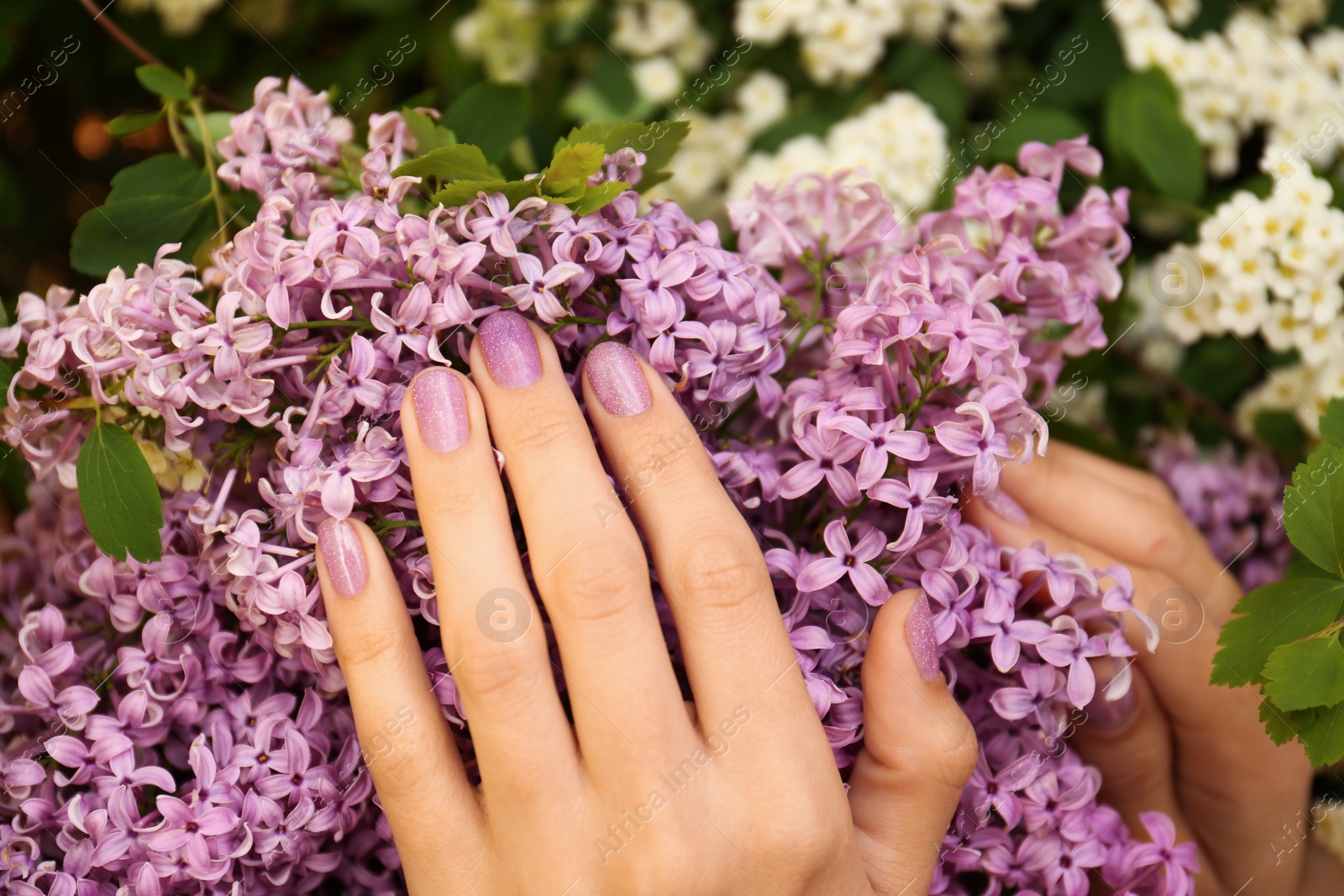 Photo of Woman with beautiful lilac flowers, closeup view