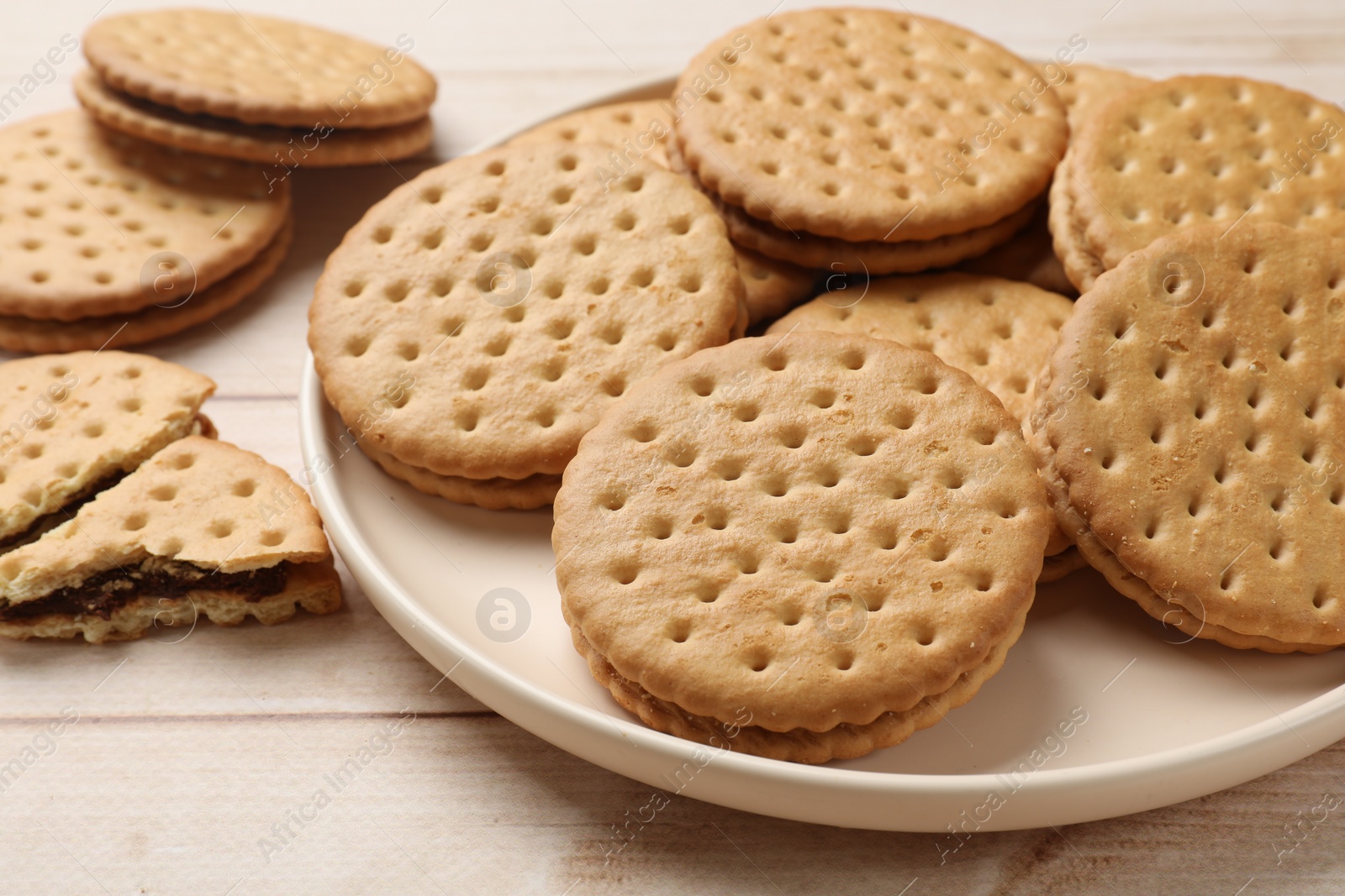 Photo of Fresh tasty sandwich cookies on wooden table, closeup