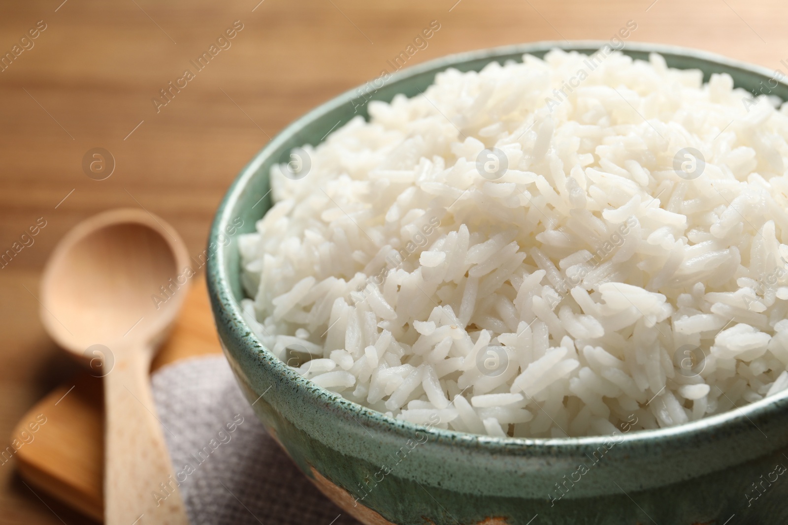 Photo of Bowl of tasty cooked rice served on table, closeup