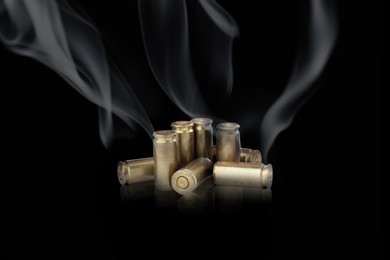 Image of Cartridge cases with smoke on black background