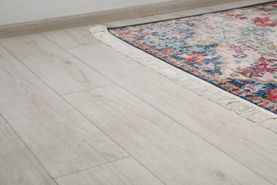 Photo of Soft carpet with pattern on white laminated floor indoors, space for text