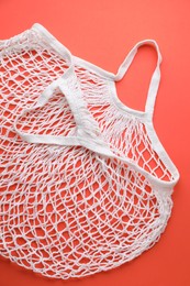 White string bag on red background, top view