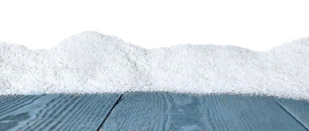 Heap of snow on grey wooden surface against white background