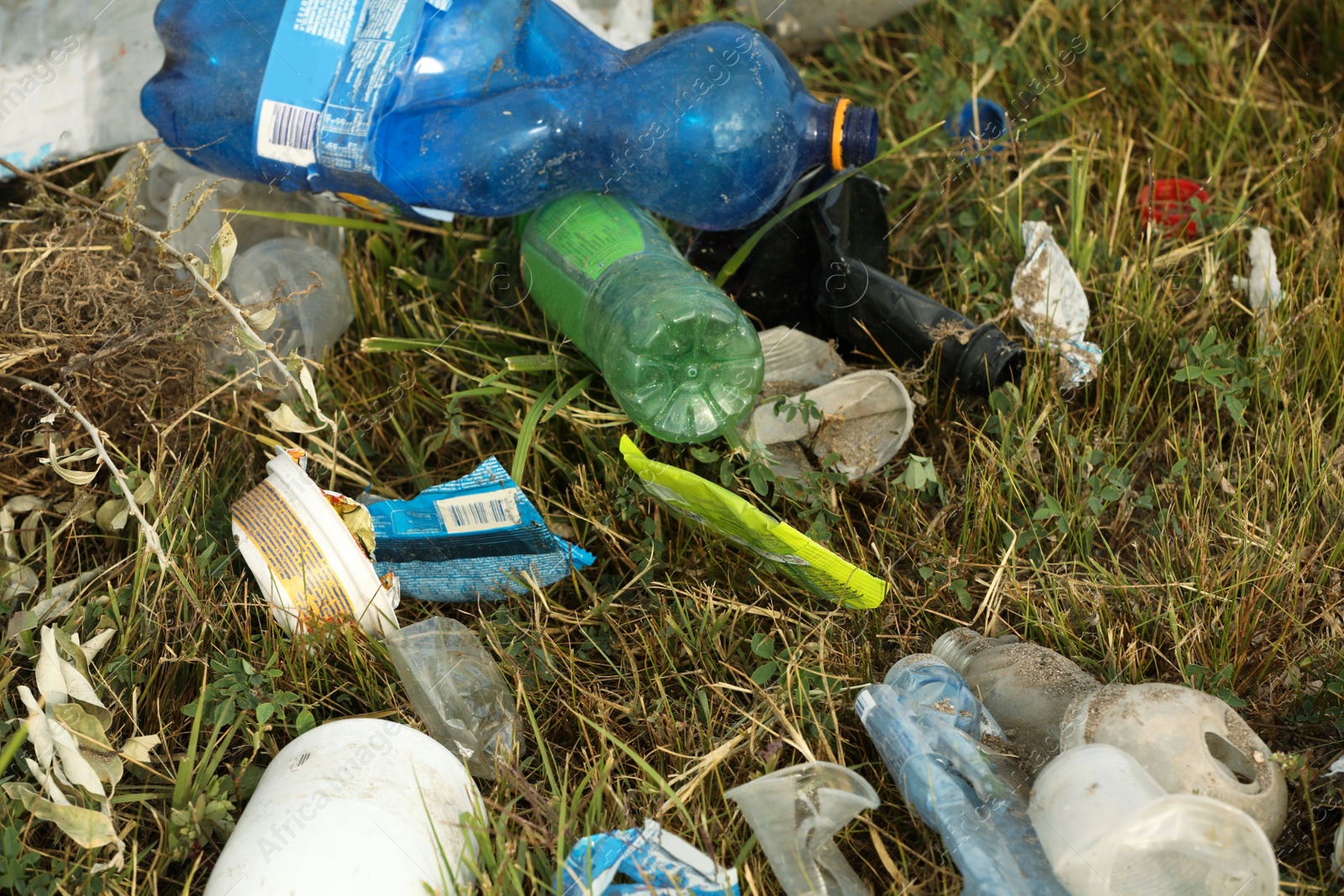 Photo of Garbage scattered on grass. Environment pollution problem