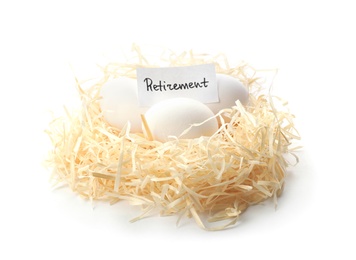 Photo of Eggs and card with word RETIREMENT in nest on white background. Pension concept