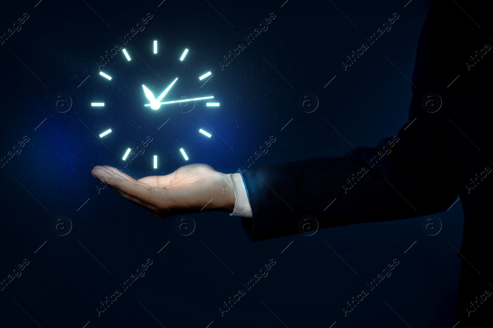 Image of Man holding virtual icon of clock on dark background, closeup. Time management