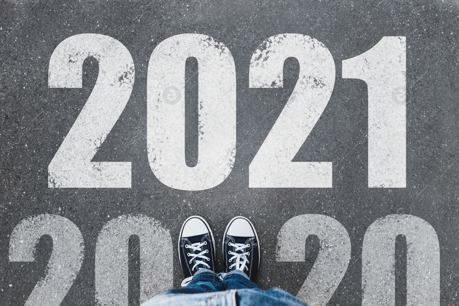 Image of Start new year with fresh vision and ideas. 2021 numbers on asphalt road in front of woman, top view