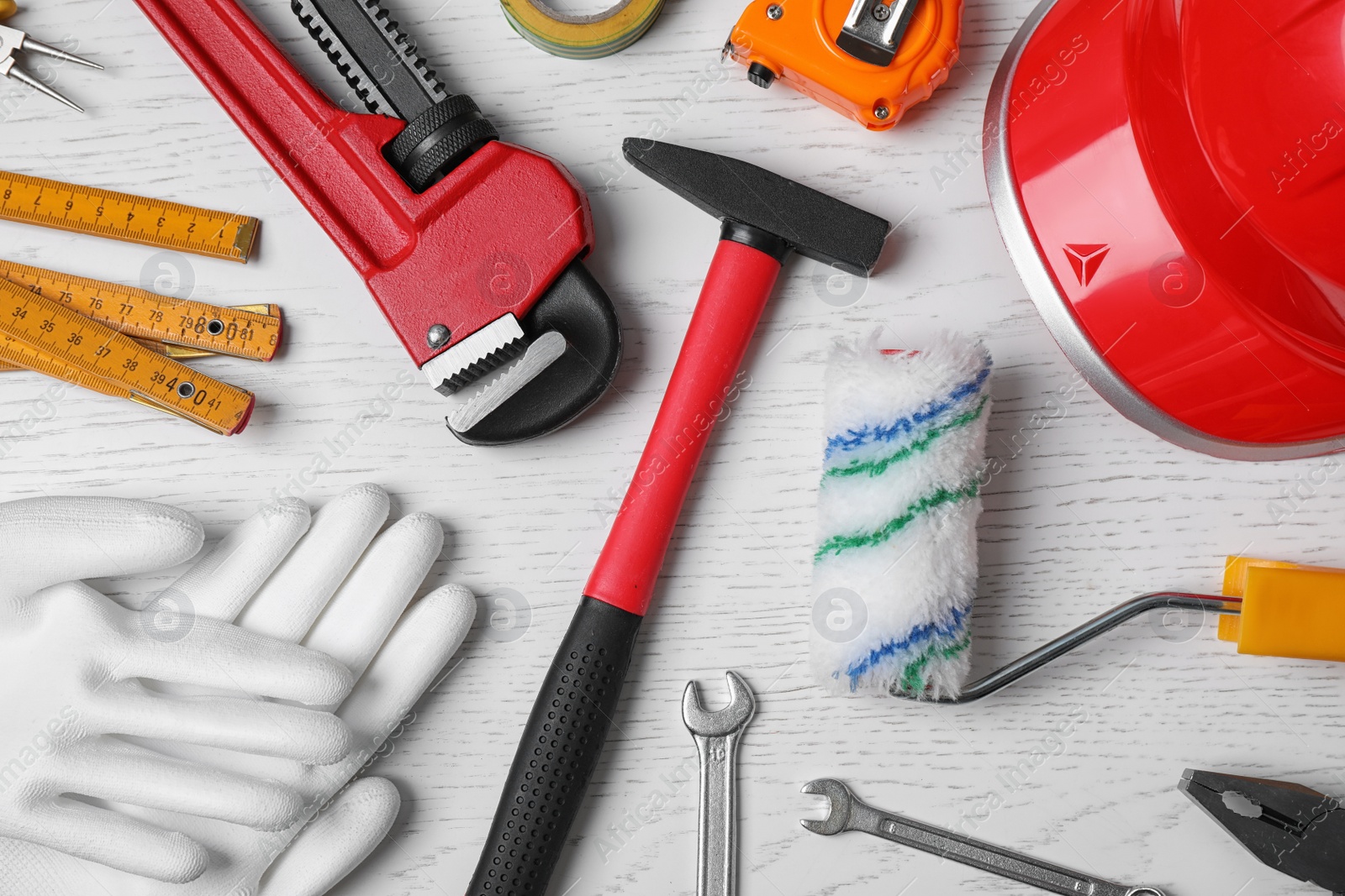 Photo of Flat lay composition with construction tools on white wooden background