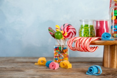 Composition with many different candies on table. Space for text