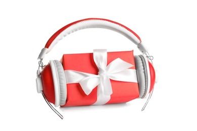 Photo of Gift box with headphones on white background. Christmas music concept
