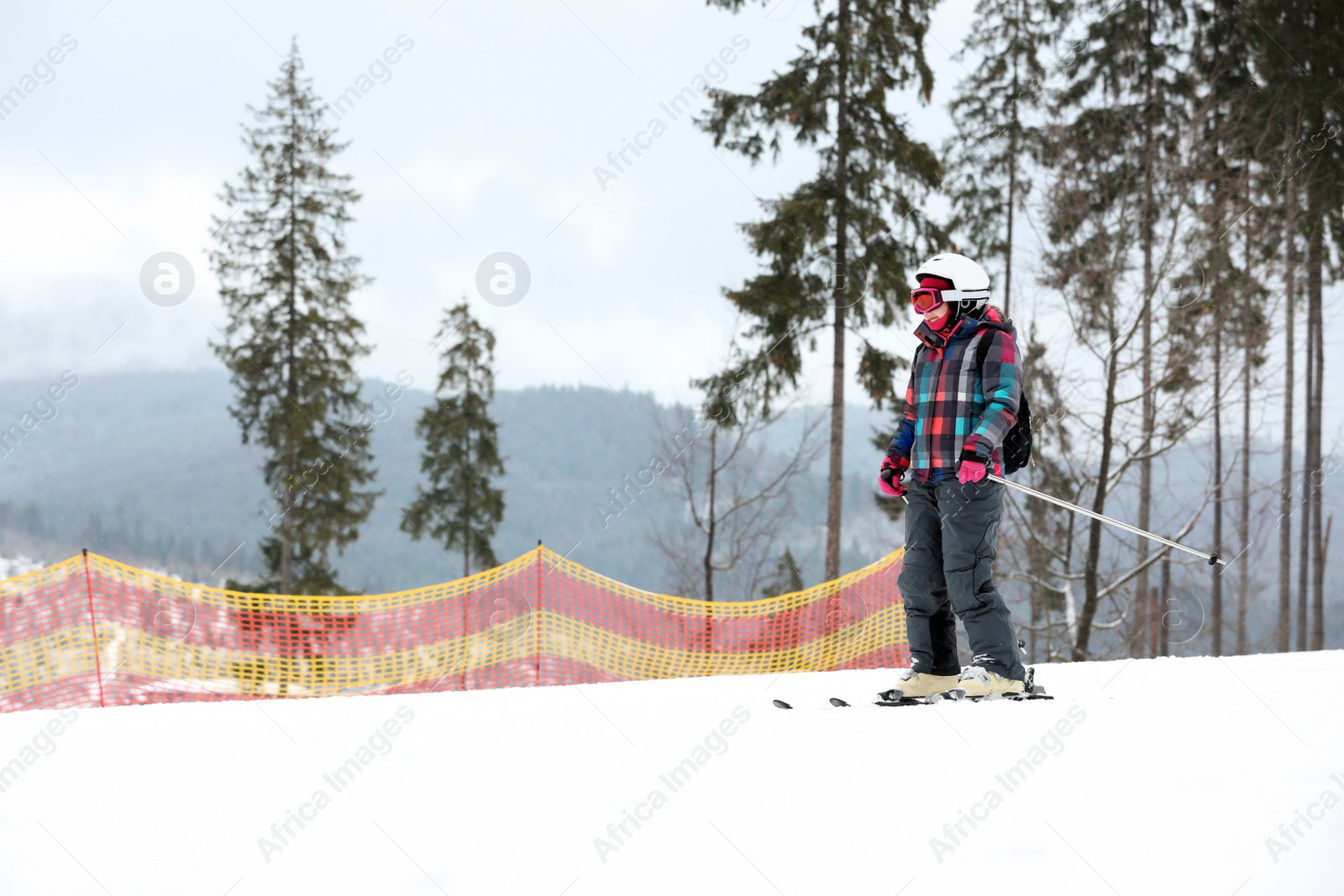 Photo of Skier on slope at resort, space for text. Winter vacation