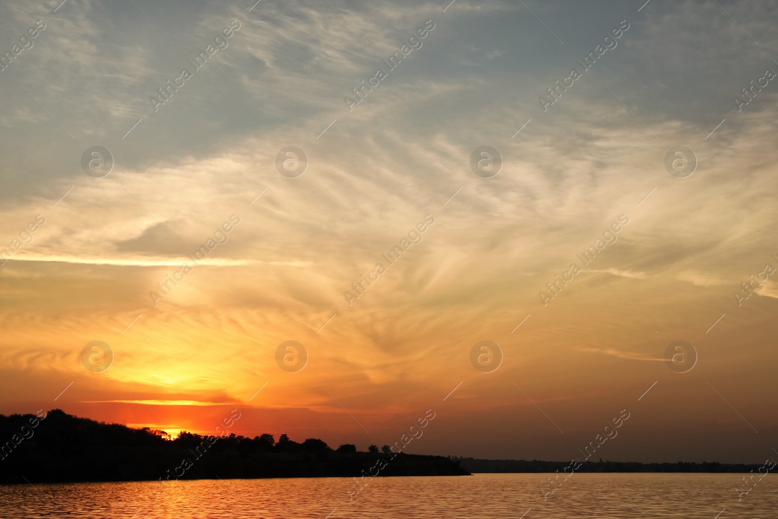 Photo of Picturesque view of tranquil river at sunset