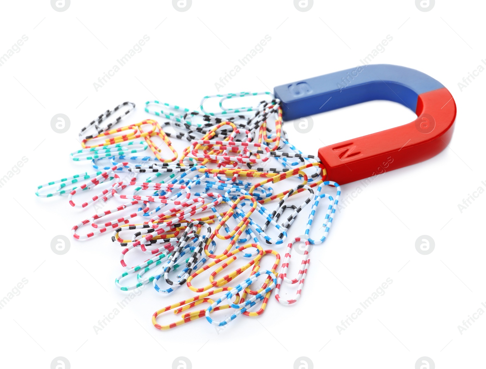 Photo of Magnet attracting paper clips on white background