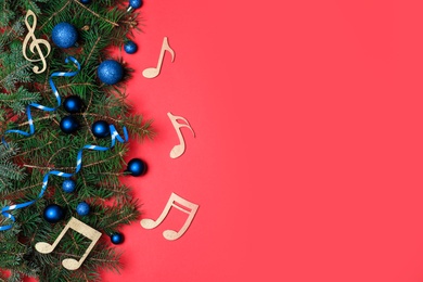 Photo of Flat lay composition with fir tree, Christmas decor and wooden music notes on color background. Space for text