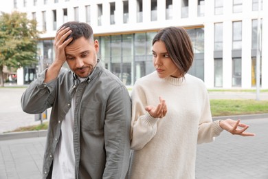 Couple arguing on city street. Relationship problems