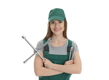 Portrait of professional auto mechanic with wrenches on white background