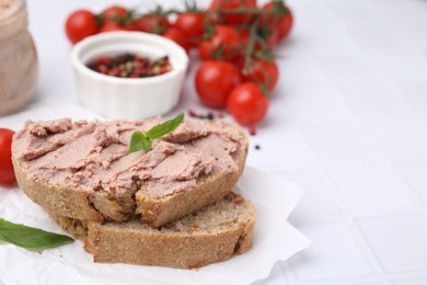 Photo of Delicious liverwurst sandwich with basil on white table, closeup. Space for text
