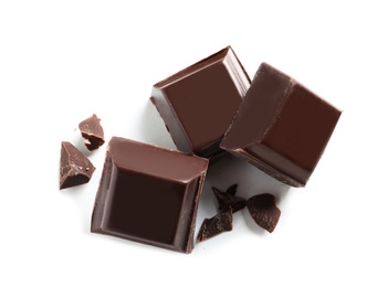 Pieces of tasty dark chocolate on white background, top view