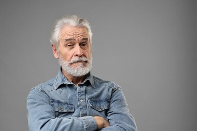 Senior man with mustache on grey background, space for text