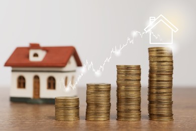 Image of Mortgage rate. Stacked coins, graph and model of house