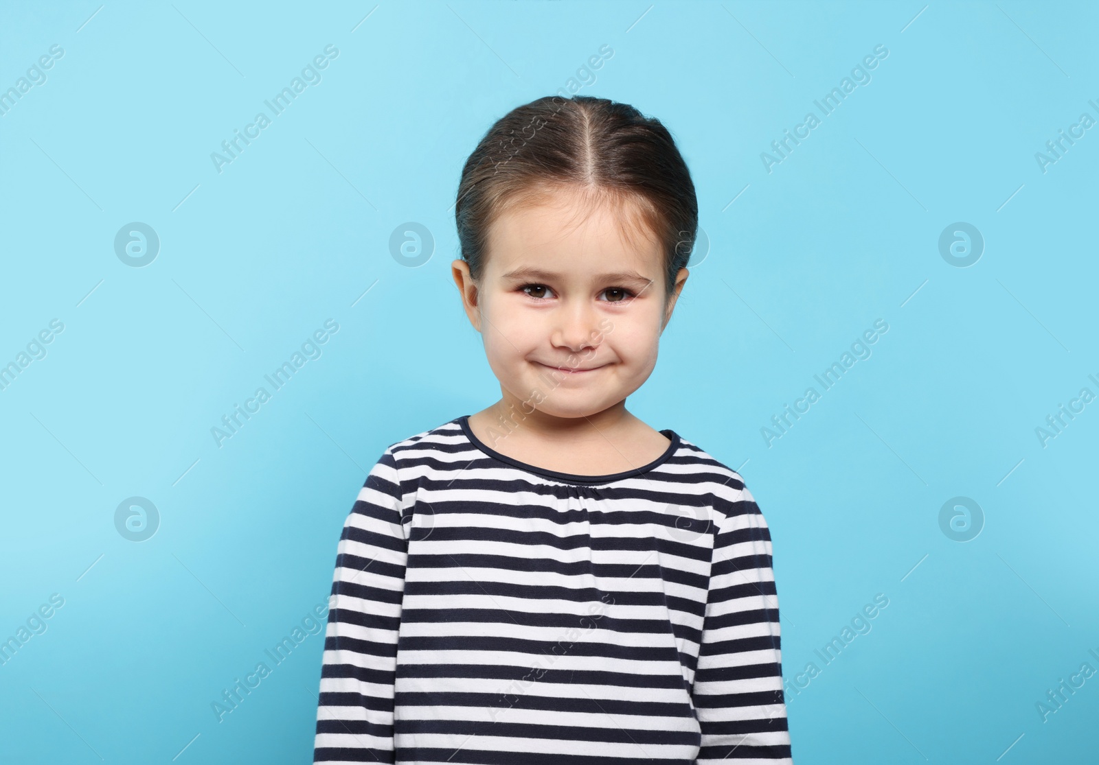 Photo of Beautiful happy girl on light blue background