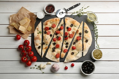 Flat lay composition with focaccia bread on white wooden table