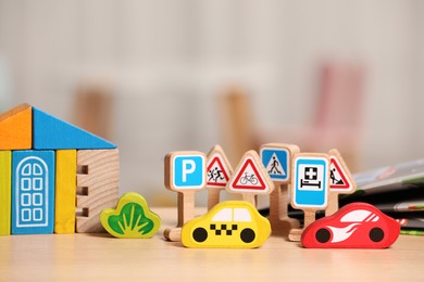 Photo of Set of wooden toys on table indoors, closeup. Space for text. Children's development
