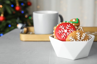 Photo of Bowl with tasty homemade Christmas cookies on table