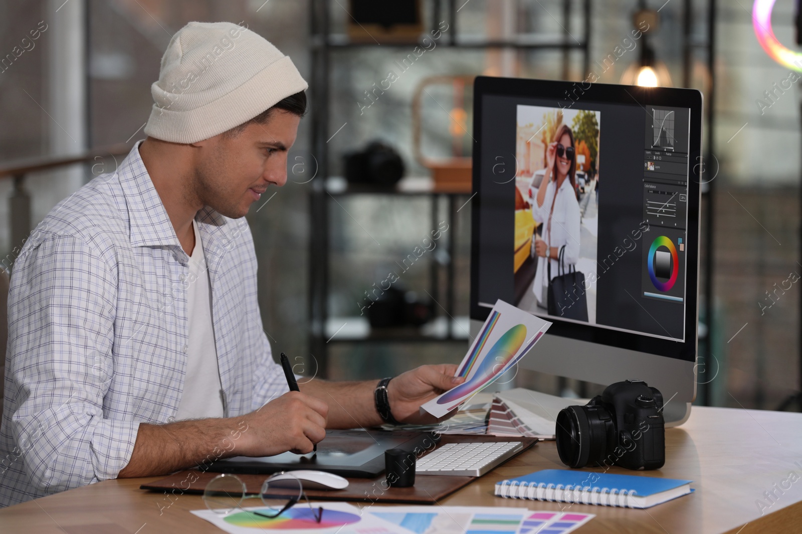 Photo of Professional retoucher working on computer in office