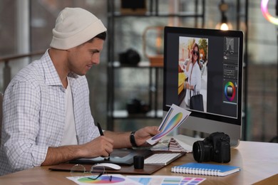 Photo of Professional retoucher working on computer in office