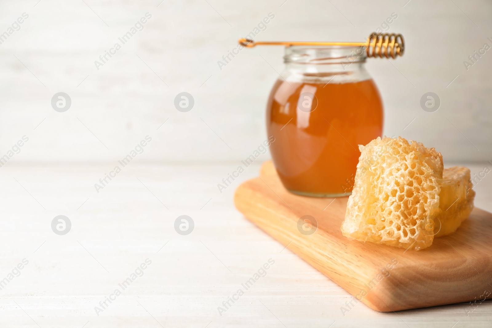 Photo of Composition with tasty fresh honeycombs on table