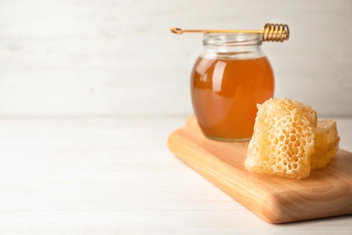 Photo of Composition with tasty fresh honeycombs on table