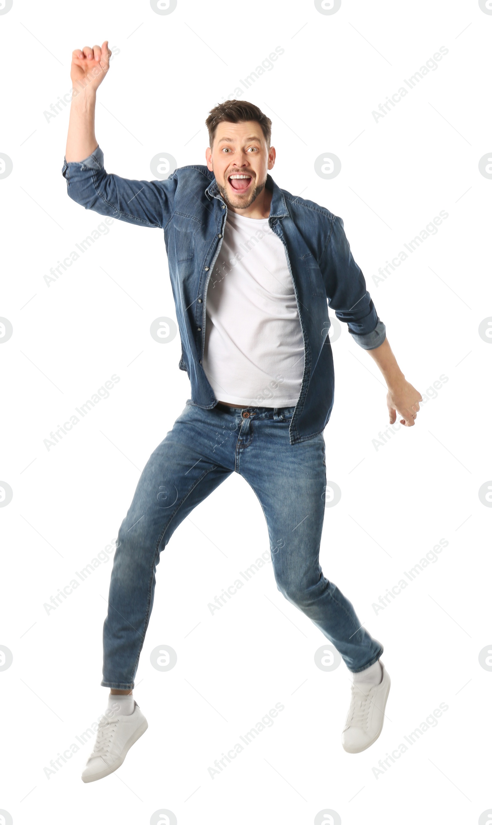 Photo of Full length portrait of happy handsome man jumping on white background