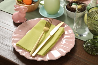 Easter celebration. Festive table setting with elegant dishware and painted eggs