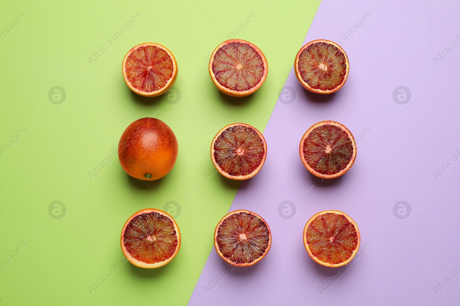 Photo of Many ripe sicilian oranges on color background, flat lay