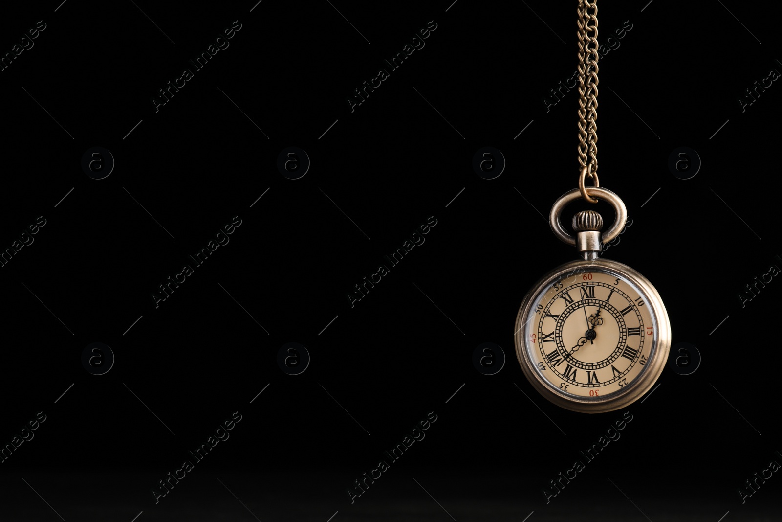 Photo of Stylish pendulum on black background, space for text. Hypnotherapy session