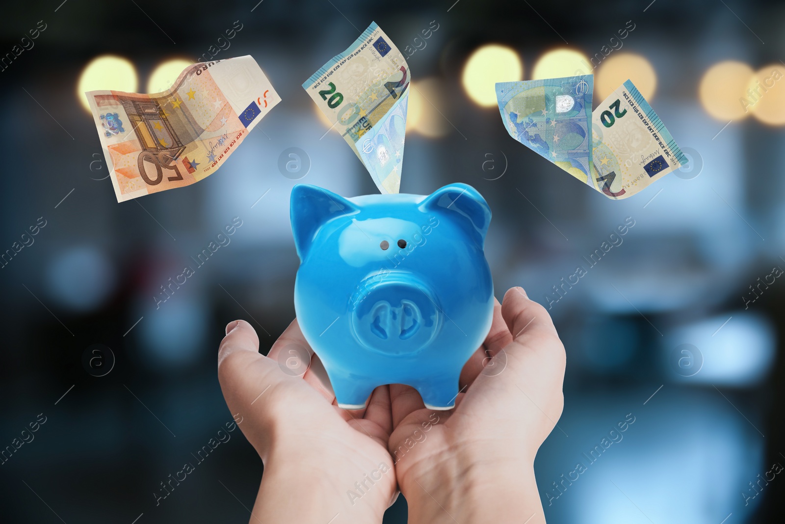 Image of Woman holding piggy bank and Euro banknotes falling outdoors, closeup