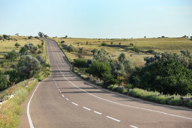 View of empty asphalt highway on sunny day