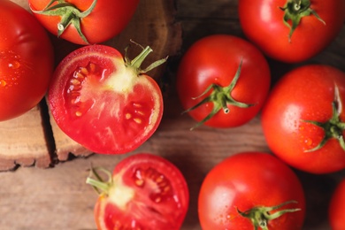 Photo of Fresh ripe tomatoes on wooden table, flat lay